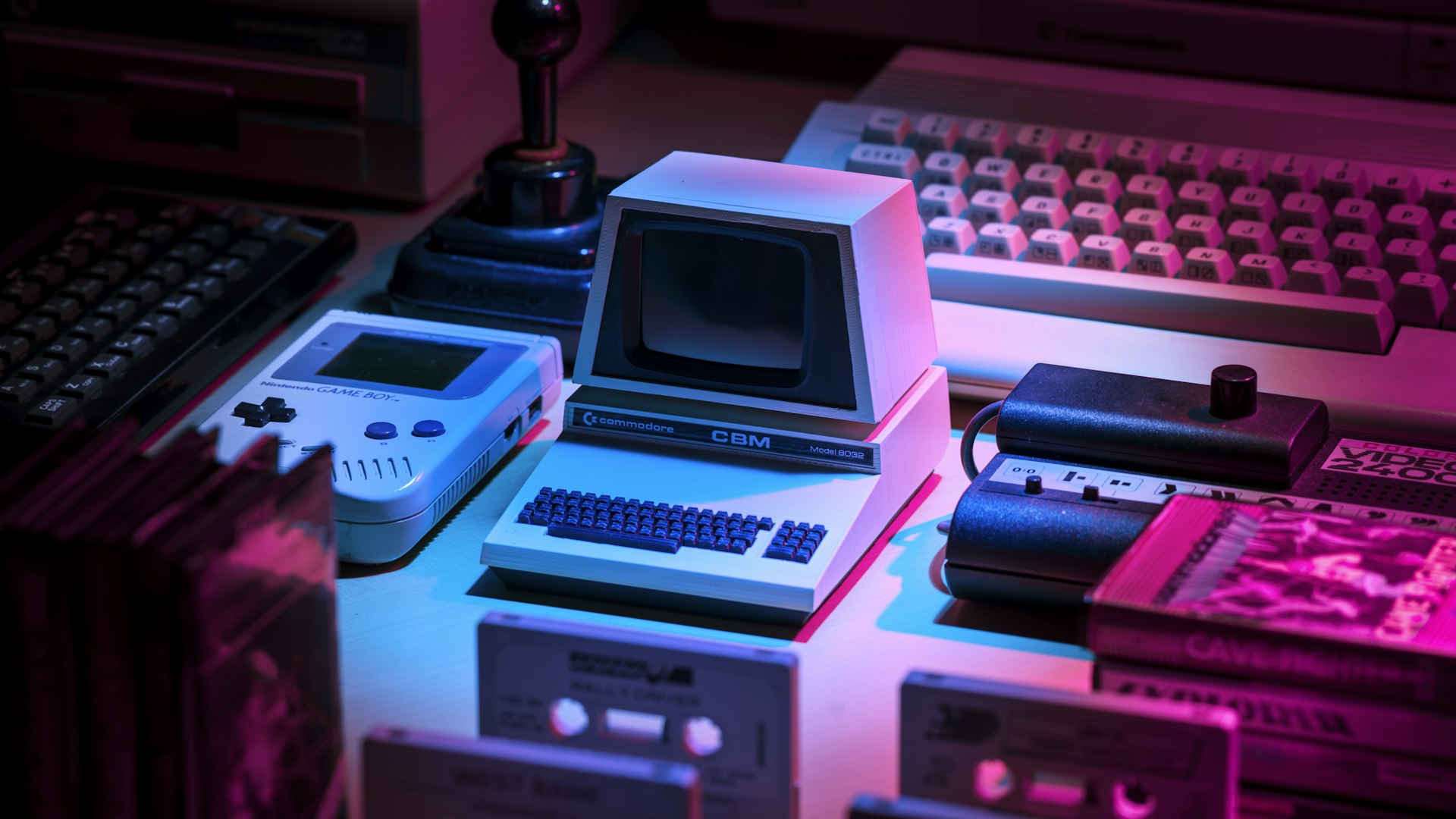 A dimly lit desk with a mechanical keyboard and monitor showing a role-playing game